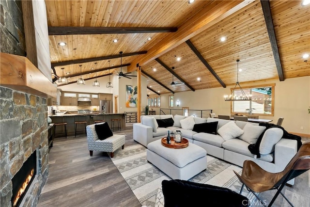 867 Clement St, South Lake Tahoe, CA 96150 - living area featuring a wood ceiling with exposed beams, recessed lighting, a fireplace, a ceiling fan, and a chandelier
