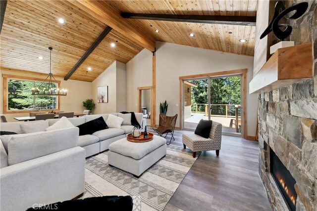 867 Clement St, South Lake Tahoe, CA 96150 - living area featuring a wooden ceiling with exposed beams, a stone fireplace, wood finished floors, high vaulted ceiling, and recessed lighting