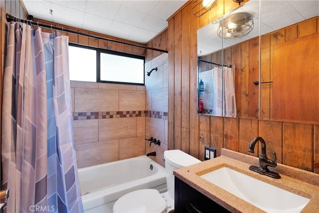 bathroom with wood walls, toilet, vanity, and shower / bathtub combination with curtain