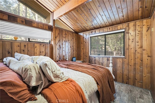 bedroom with wood finished floors, wood walls, wooden ceiling, and multiple windows