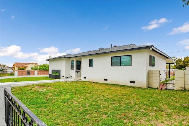 12643 Gladstone Ave, Sylmar, CA 91342 - back of house featuring fence, crawl space, a yard, and stucco siding