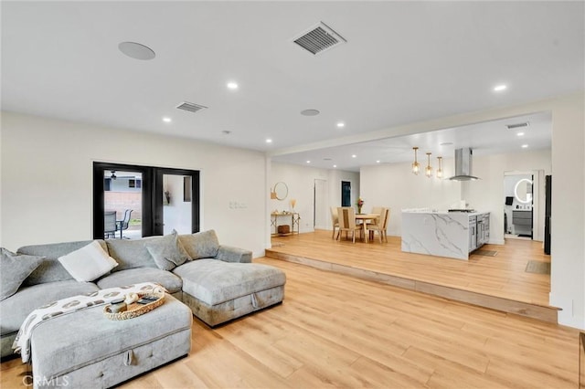 12643 Gladstone Ave, Sylmar, CA 91342 - living area with visible vents, recessed lighting, and light wood-style floors