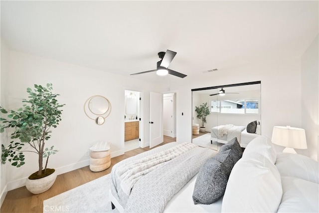 bedroom featuring baseboards, ceiling fan, light wood-type flooring, and visible vents