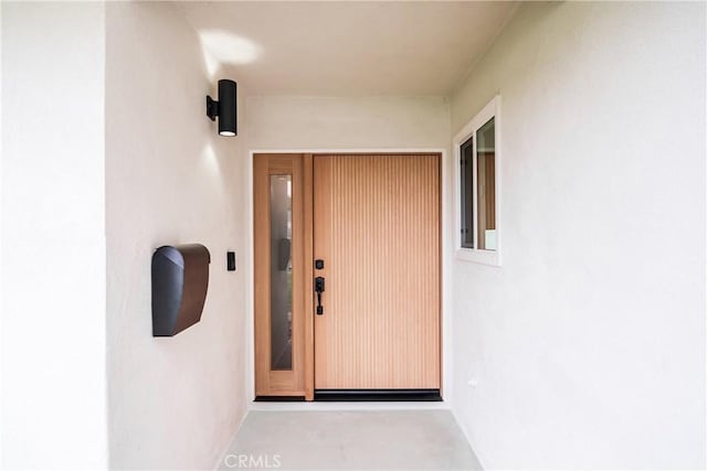 doorway to property with stucco siding