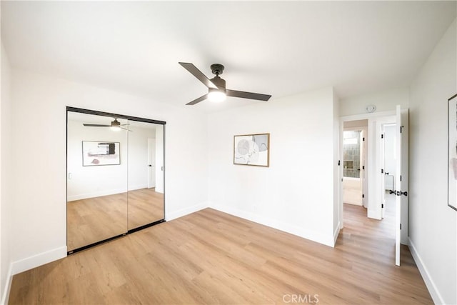 unfurnished bedroom with baseboards, a ceiling fan, and light wood-style flooring