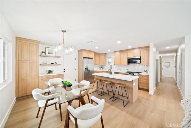 dining area featuring light wood-type flooring, recessed lighting, and baseboards