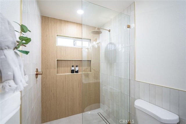 full bathroom with tile walls, walk in shower, and toilet