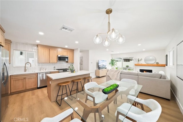 dining area with recessed lighting, light wood-style flooring, and visible vents