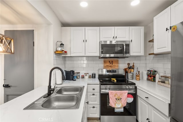 2265 Bradford Ave Unit 516, Highland, CA 92346 - kitchen with appliances with stainless steel finishes, a sink, white cabinetry, light countertops, and tasteful backsplash