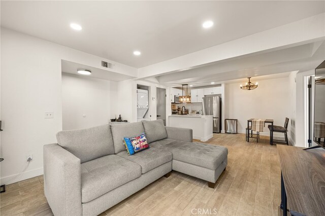 2265 Bradford Ave Unit 516, Highland, CA 92346 - living room featuring recessed lighting, light wood-style flooring, baseboards, and a chandelier