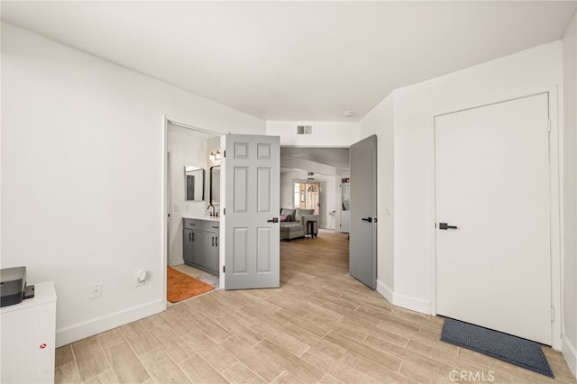 2265 Bradford Ave Unit 516, Highland, CA 92346 - unfurnished bedroom with light wood-type flooring, baseboards, and connected bathroom