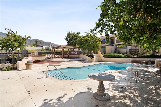 2265 Bradford Ave Unit 516, Highland, CA 92346 - community pool featuring a patio, a mountain view, and stairway