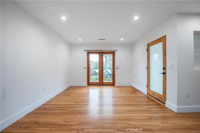 interior space featuring french doors, recessed lighting, and light wood-style floors