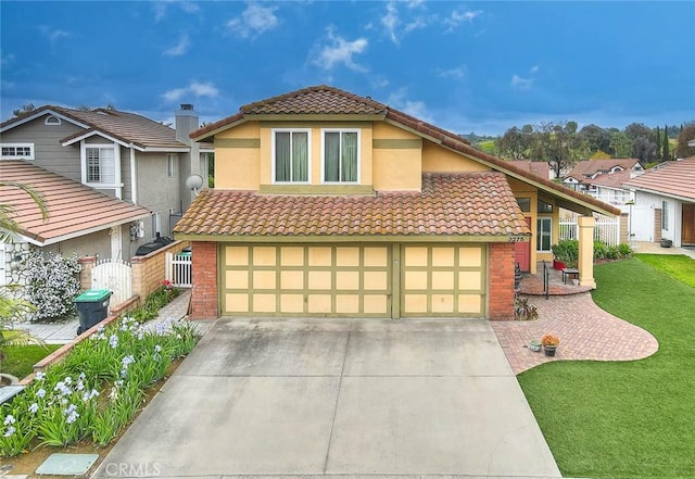 view of front facade with fence, a tile roof, an attached garage, and concrete driveway