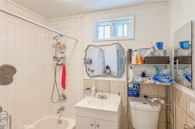 927 E 28th St, Los Angeles, CA 90011 - bathroom with tile walls, shower / bath combination, vanity, and toilet