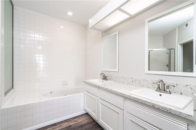 230 Lille Ln Unit 214, Newport Beach, CA 92663 - full bathroom with a shower stall, tiled tub, wood finished floors, and a sink