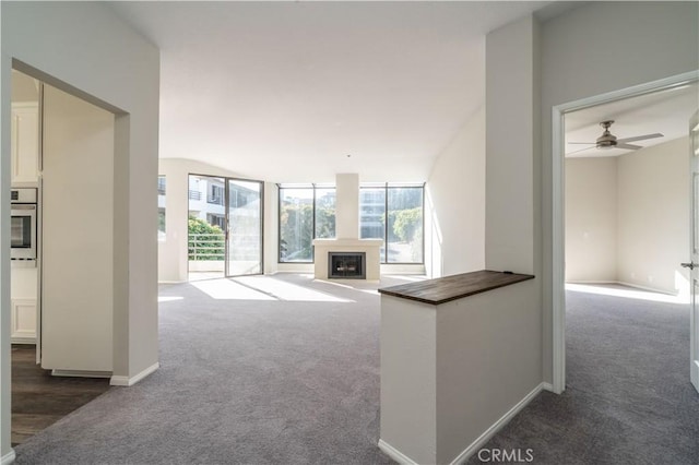 230 Lille Ln Unit 214, Newport Beach, CA 92663 - unfurnished living room with carpet floors, a ceiling fan, and a fireplace