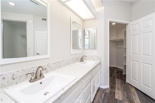 230 Lille Ln Unit 214, Newport Beach, CA 92663 - full bathroom featuring double vanity, wood finished floors, visible vents, and a sink