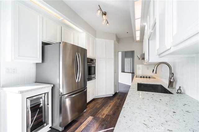 230 Lille Ln Unit 214, Newport Beach, CA 92663 - kitchen with a sink, appliances with stainless steel finishes, white cabinetry, backsplash, and dark wood-style flooring
