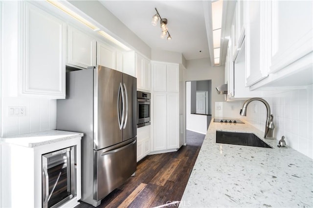 230 Lille Ln Unit 214, Newport Beach, CA 92663 - kitchen with stainless steel appliances, dark wood finished floors, tasteful backsplash, white cabinetry, and light stone countertops