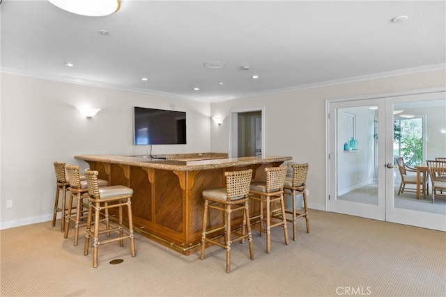 230 Lille Ln Unit 214, Newport Beach, CA 92663 - bar with light carpet, ornamental molding, and french doors