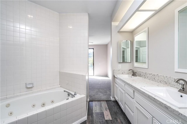230 Lille Ln Unit 214, Newport Beach, CA 92663 - bathroom featuring wood finished floors, a sink, a whirlpool tub, and double vanity