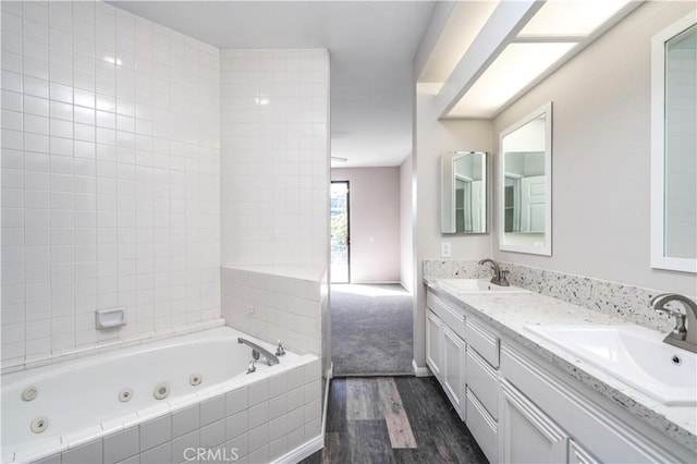230 Lille Ln Unit 214, Newport Beach, CA 92663 - full bath with a tub with jets, wood finished floors, and double vanity