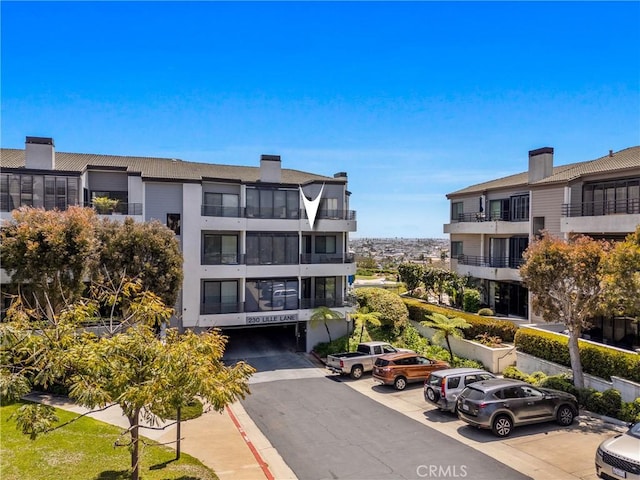 230 Lille Ln Unit 214, Newport Beach, CA 92663 - view of building exterior with uncovered parking