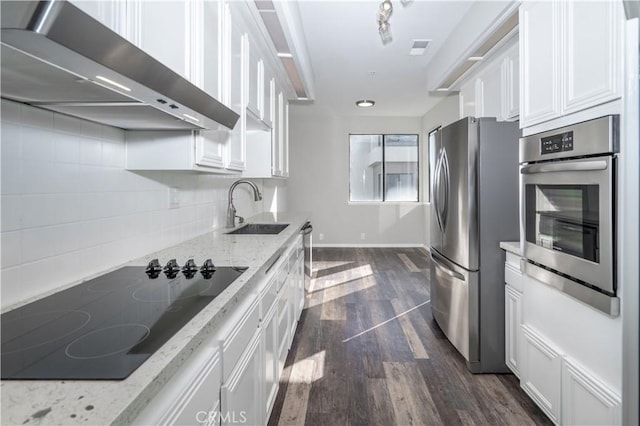 230 Lille Ln Unit 214, Newport Beach, CA 92663 - kitchen featuring wall chimney range hood, a sink, appliances with stainless steel finishes, white cabinetry, and dark wood-style flooring