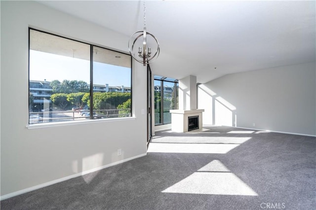 230 Lille Ln Unit 214, Newport Beach, CA 92663 - unfurnished living room with a fireplace with flush hearth, carpet floors, baseboards, and a notable chandelier