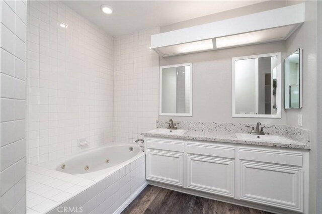 230 Lille Ln Unit 214, Newport Beach, CA 92663 - full bath with double vanity, wood finished floors, a tub with jets, and a sink
