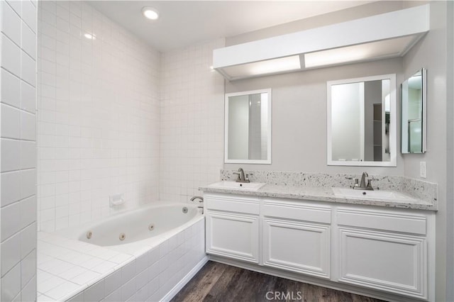 230 Lille Ln Unit 214, Newport Beach, CA 92663 - full bathroom with wood finished floors, a whirlpool tub, and double vanity