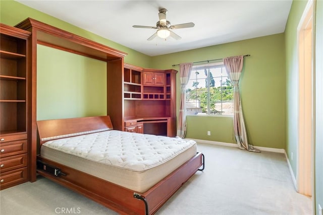 bedroom featuring baseboards, a ceiling fan, and light carpet