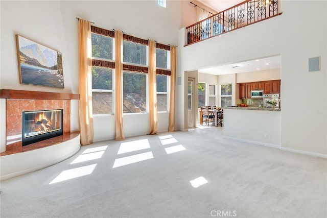 unfurnished living room featuring light colored carpet and a premium fireplace