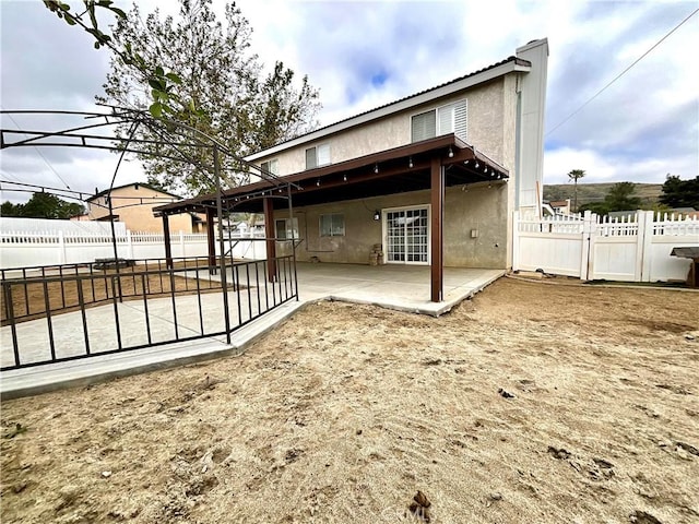 1078 W King St, Banning, CA 92220 - rear view of property with a gate, stucco siding, a fenced backyard, and a patio area
