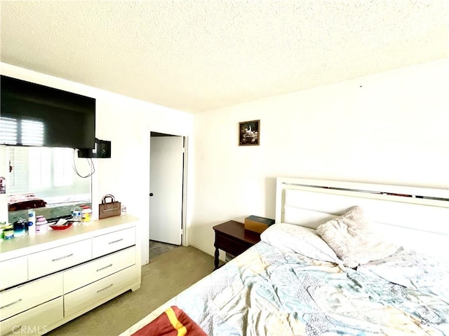1078 W King St, Banning, CA 92220 - bedroom featuring a textured ceiling and light carpet