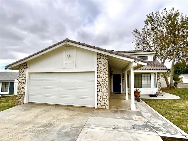 1078 W King St, Banning, CA 92220 - view of front facade with driveway, stone siding, a tiled roof, and a garage