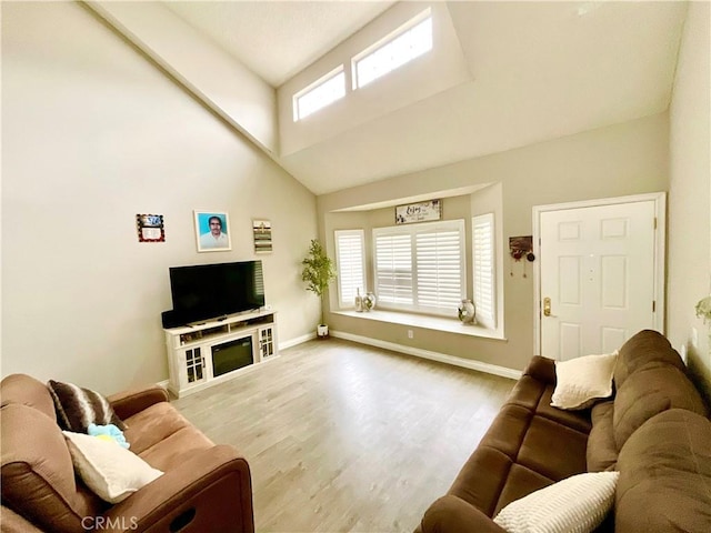 1078 W King St, Banning, CA 92220 - living room with high vaulted ceiling, wood finished floors, and baseboards