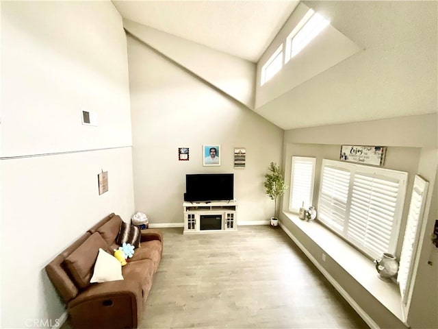 1078 W King St, Banning, CA 92220 - living room with visible vents, high vaulted ceiling, wood finished floors, and baseboards