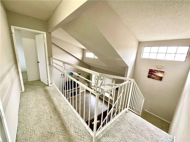 1078 W King St, Banning, CA 92220 - stairway featuring baseboards, a textured ceiling, and carpet