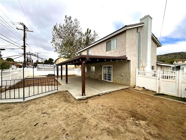 1078 W King St, Banning, CA 92220 - back of property featuring stucco siding, a fenced backyard, and a patio area