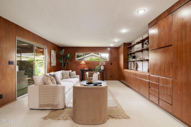 living room with wooden walls and recessed lighting