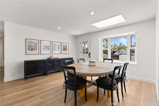 2343 E Athens Ave, Orange, CA 92867 - dining area featuring a skylight, baseboards, recessed lighting, and light wood finished floors