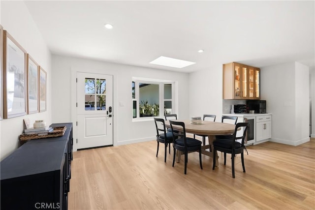 2343 E Athens Ave, Orange, CA 92867 - dining area featuring baseboards, recessed lighting, light wood-style flooring, and a skylight