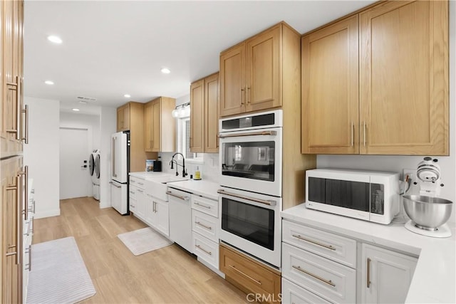 2343 E Athens Ave, Orange, CA 92867 - kitchen with a sink, white appliances, light countertops, light wood-style flooring, and recessed lighting