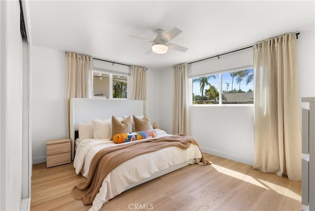 2343 E Athens Ave, Orange, CA 92867 - bedroom with baseboards, multiple windows, and light wood-style floors
