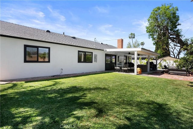 2343 E Athens Ave, Orange, CA 92867 - back of house featuring roof with shingles, a chimney, a ceiling fan, a patio area, and a lawn