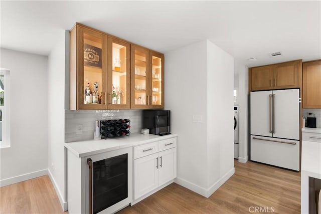 2343 E Athens Ave, Orange, CA 92867 - bar with freestanding refrigerator, beverage cooler, baseboards, light wood-type flooring, and tasteful backsplash