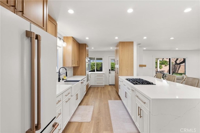 2343 E Athens Ave, Orange, CA 92867 - kitchen featuring light wood-style floors, gas cooktop, a sink, a wealth of natural light, and white fridge