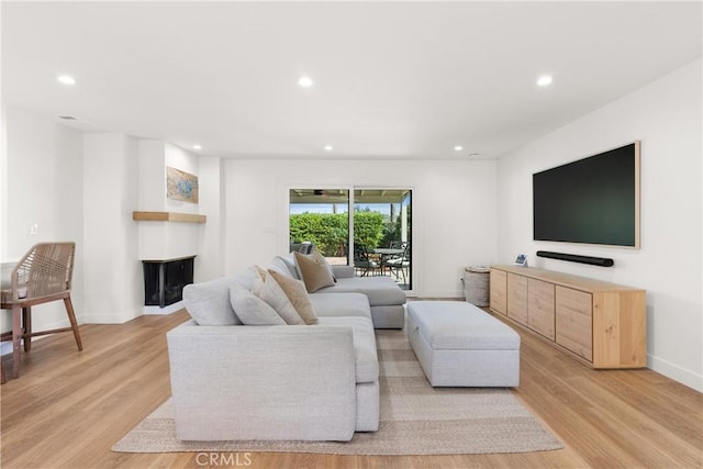 2343 E Athens Ave, Orange, CA 92867 - living area featuring a multi sided fireplace, baseboards, recessed lighting, and light wood-style flooring